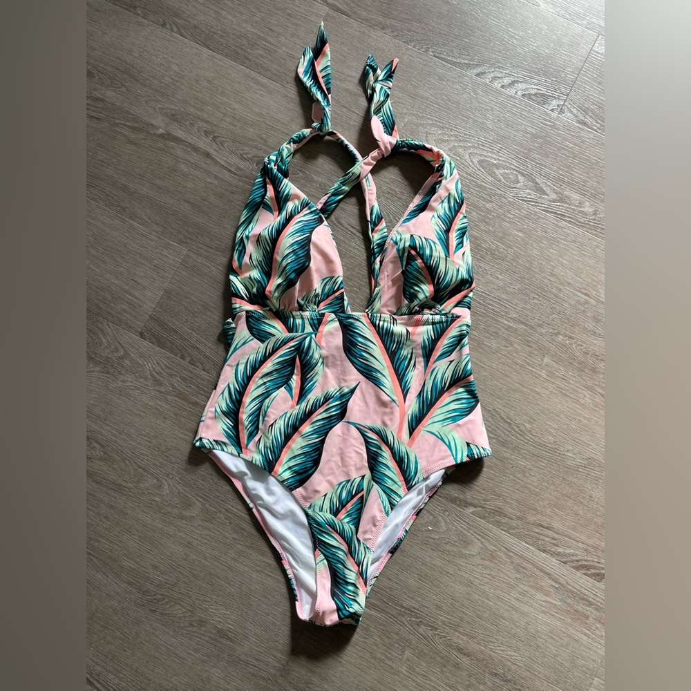 Pink plunging bathing suit with palm leaves